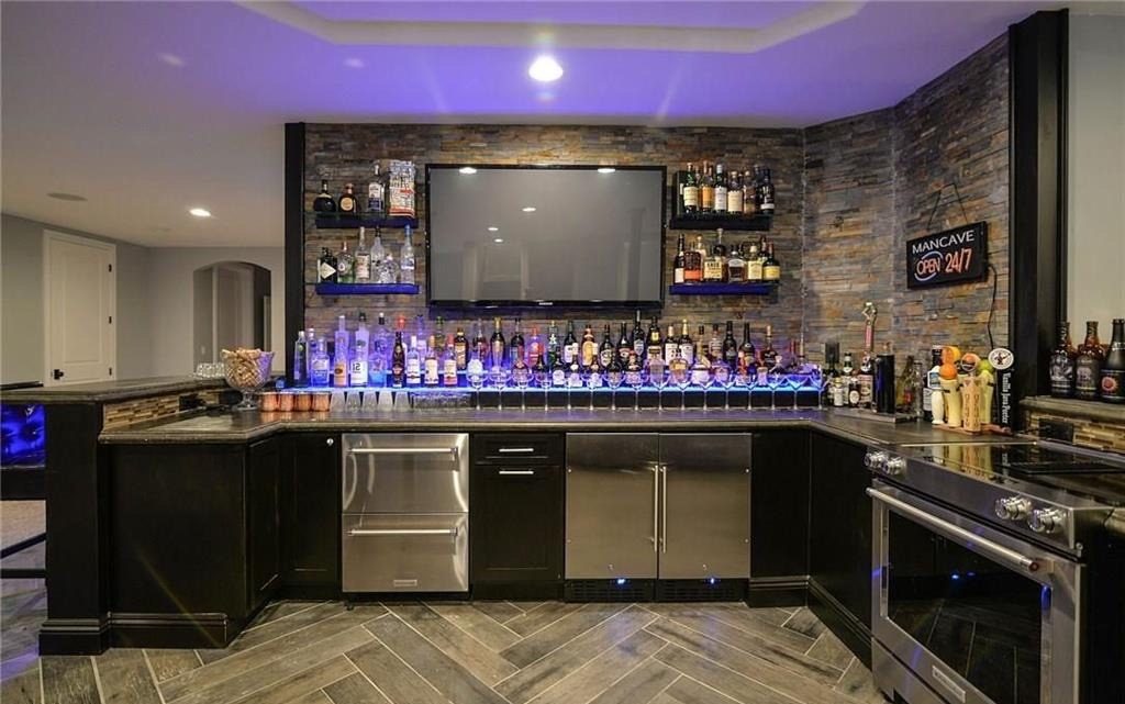 Finished basement wet bar with stone surround and herringbone tile floor, Oakland County Michigan