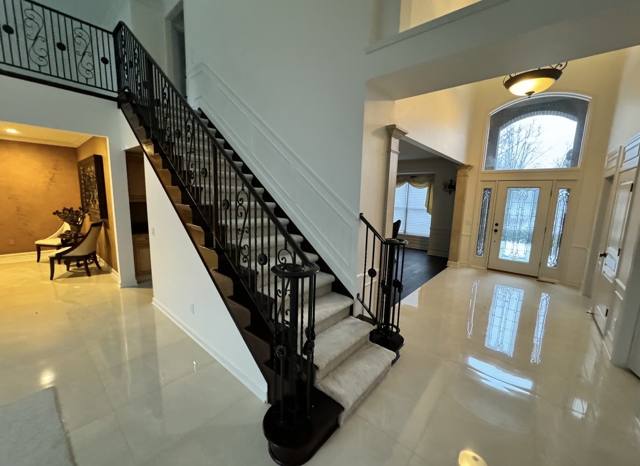 Renovated entry and staircase with wrought iron railing, Northville remodel by Mount Vernon Construction