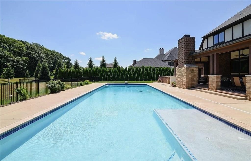 Inground pool with stone decking and landscaped surrounds, built by Mount Vernon Construction